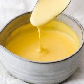 Hollandaise sauce dripping off a spoon.
