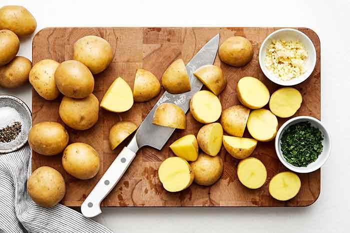 Slicing potatoes on a board.