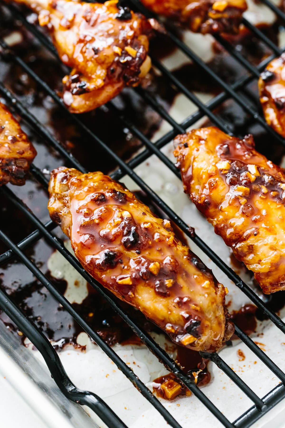 A chicken wing coated in soy ginger garlic sauce.