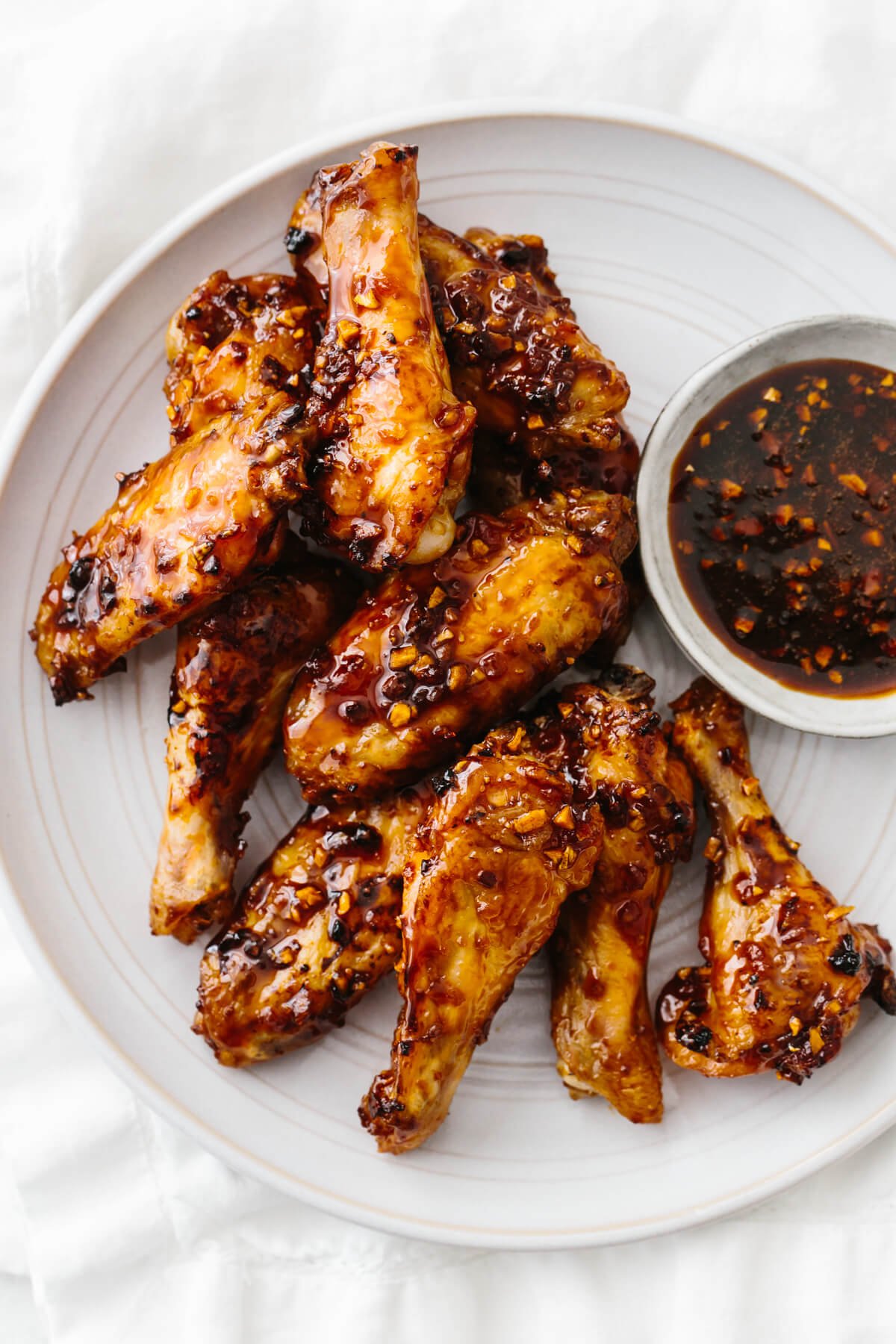 Soy garlic ginger chicken wings on a plate.