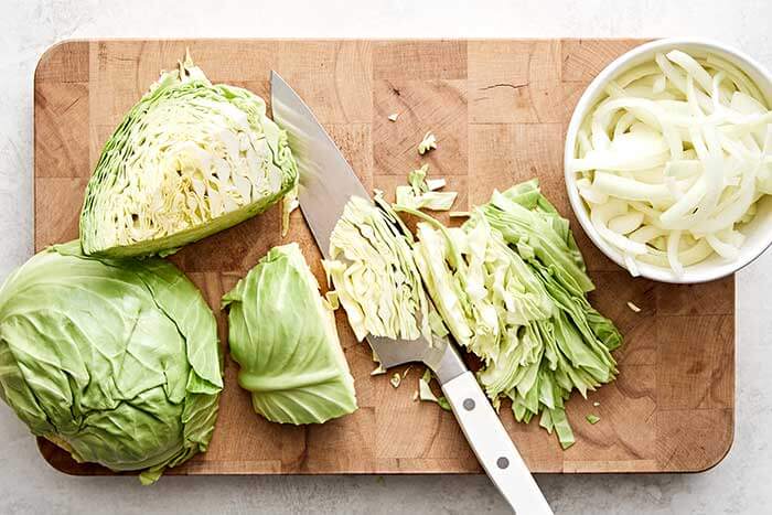 Sliced cabbage on a wooden board.