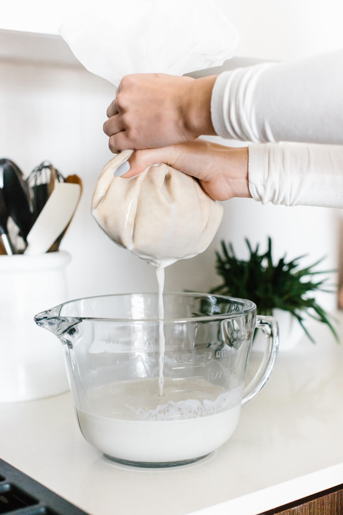 Straining oat milk recipe.