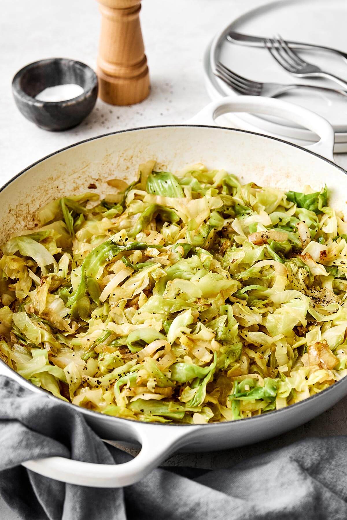 A white pan of sauteed cabbage.