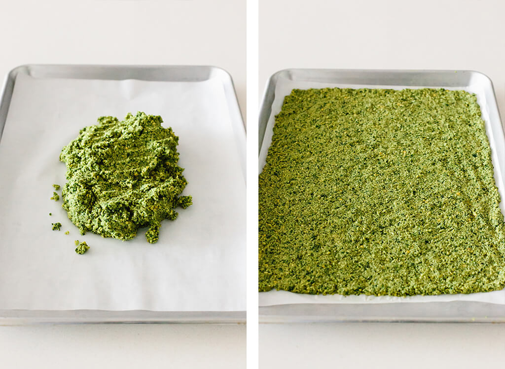 Flattening falafel flatbread dough on baking sheet.
