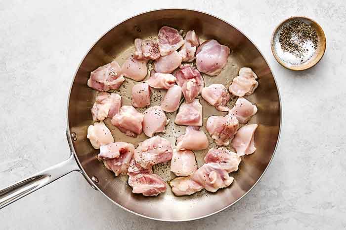 Cooking chicken in a pan.