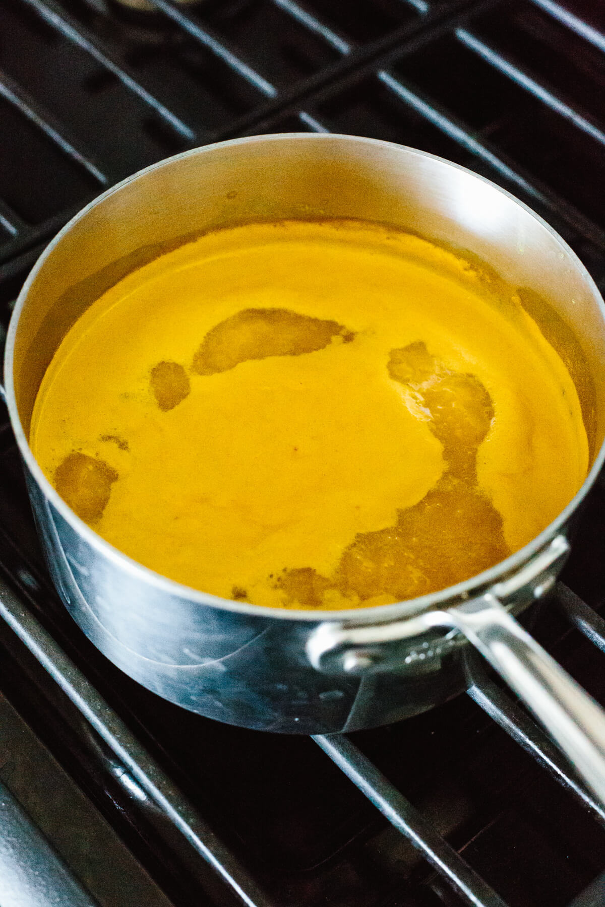 Jamu juice is an Indonesian anti-inflammatory drink that's a blend of fresh turmeric, ginger, lemon, water, and honey. A pot boiling jamu juice.