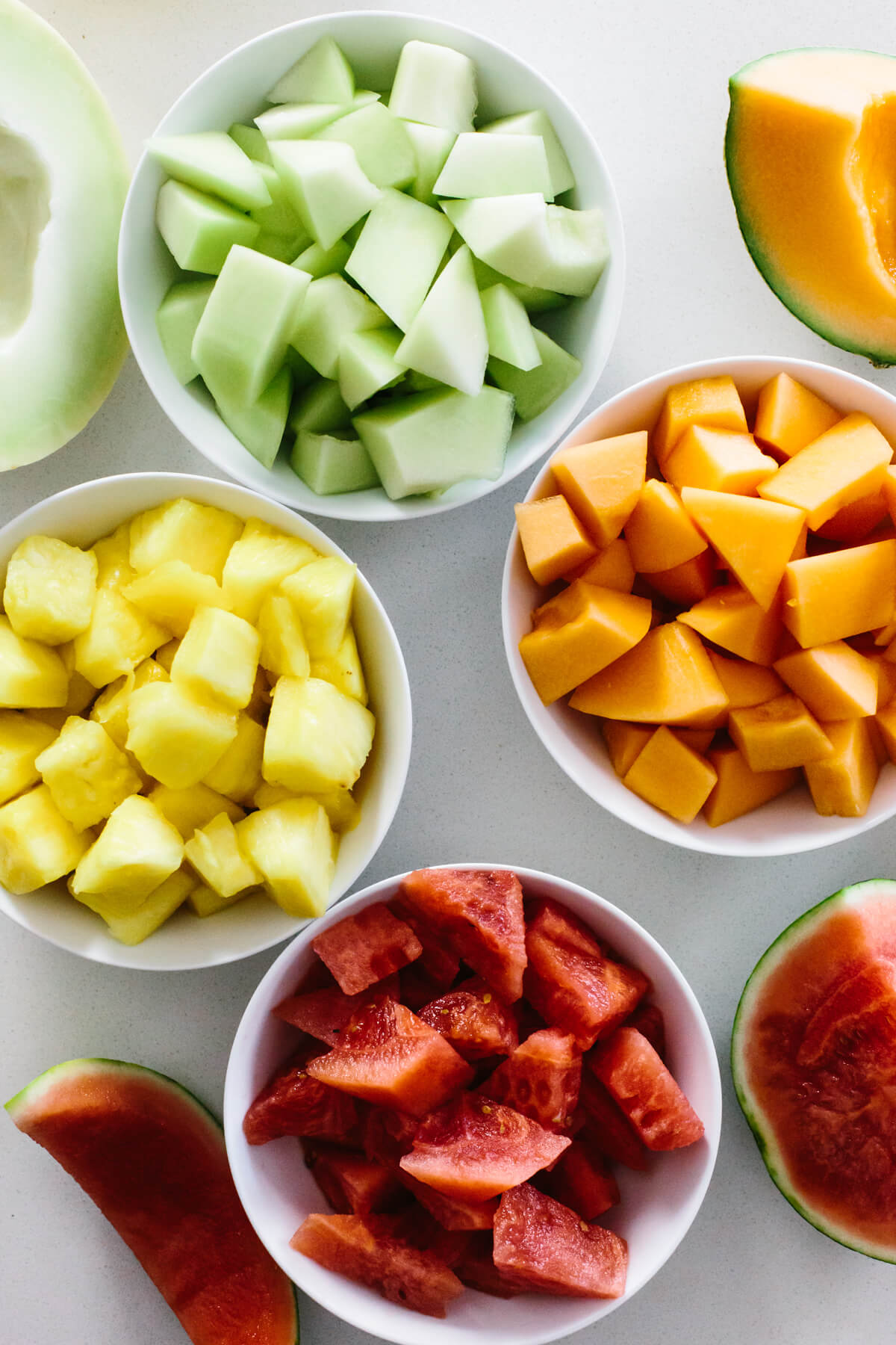 Agua fresca is an easy, refreshing fruit drink made from fruit, water, lime juice and a little sweetener! A variety of cut fruit in bowls.
