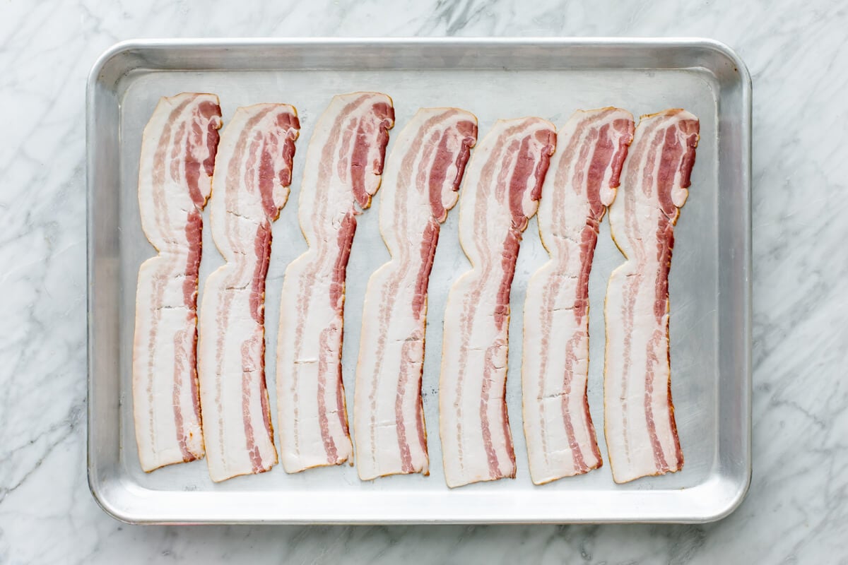 Baking bacon on a sheet pan for shrimp tacos.