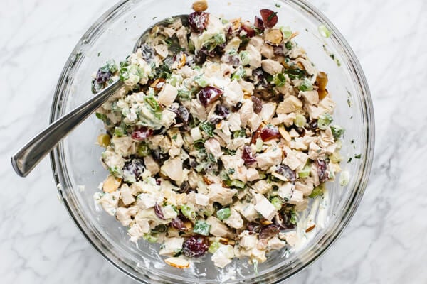 Mixing the ingredients for chicken salad in a bowl.