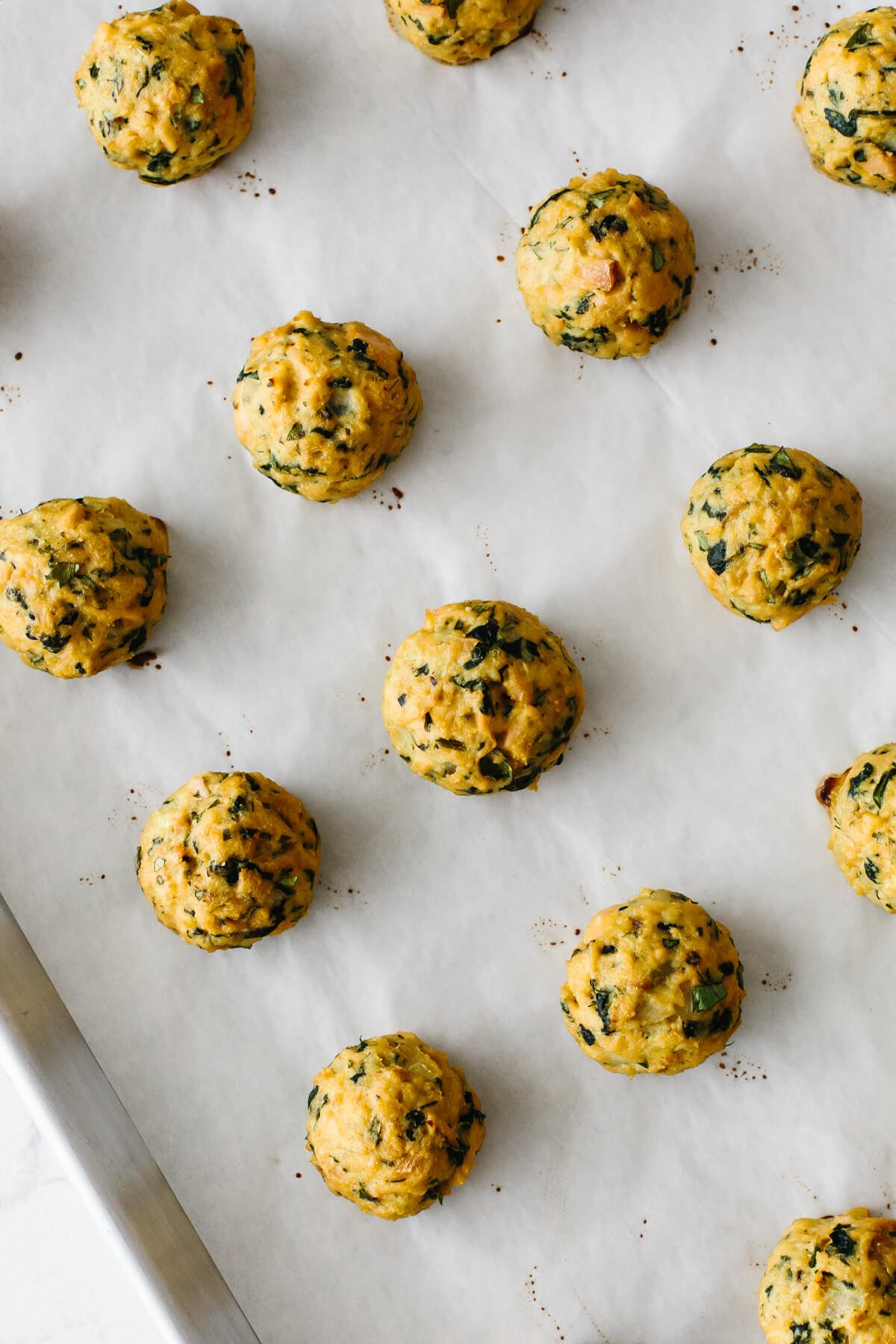 Baked tuna meatballs are a healthy, low-carb, seafood spin on meatballs! Tuna meatballs that have been cooked on a baking tray.