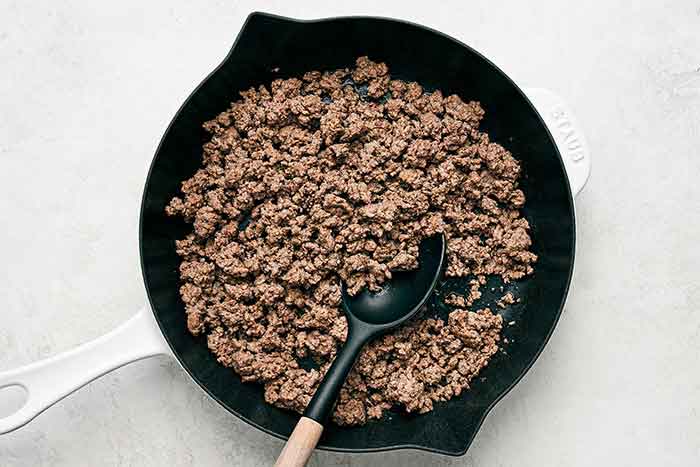 Cooked ground beef in a skillet.