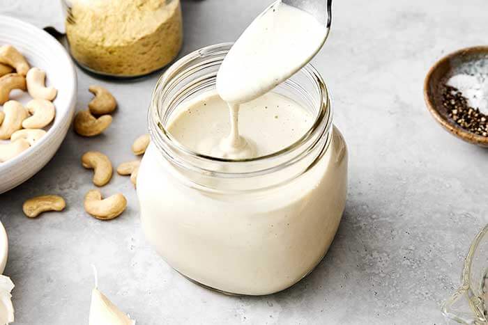 A spoonful of vegan alfredo sauce.