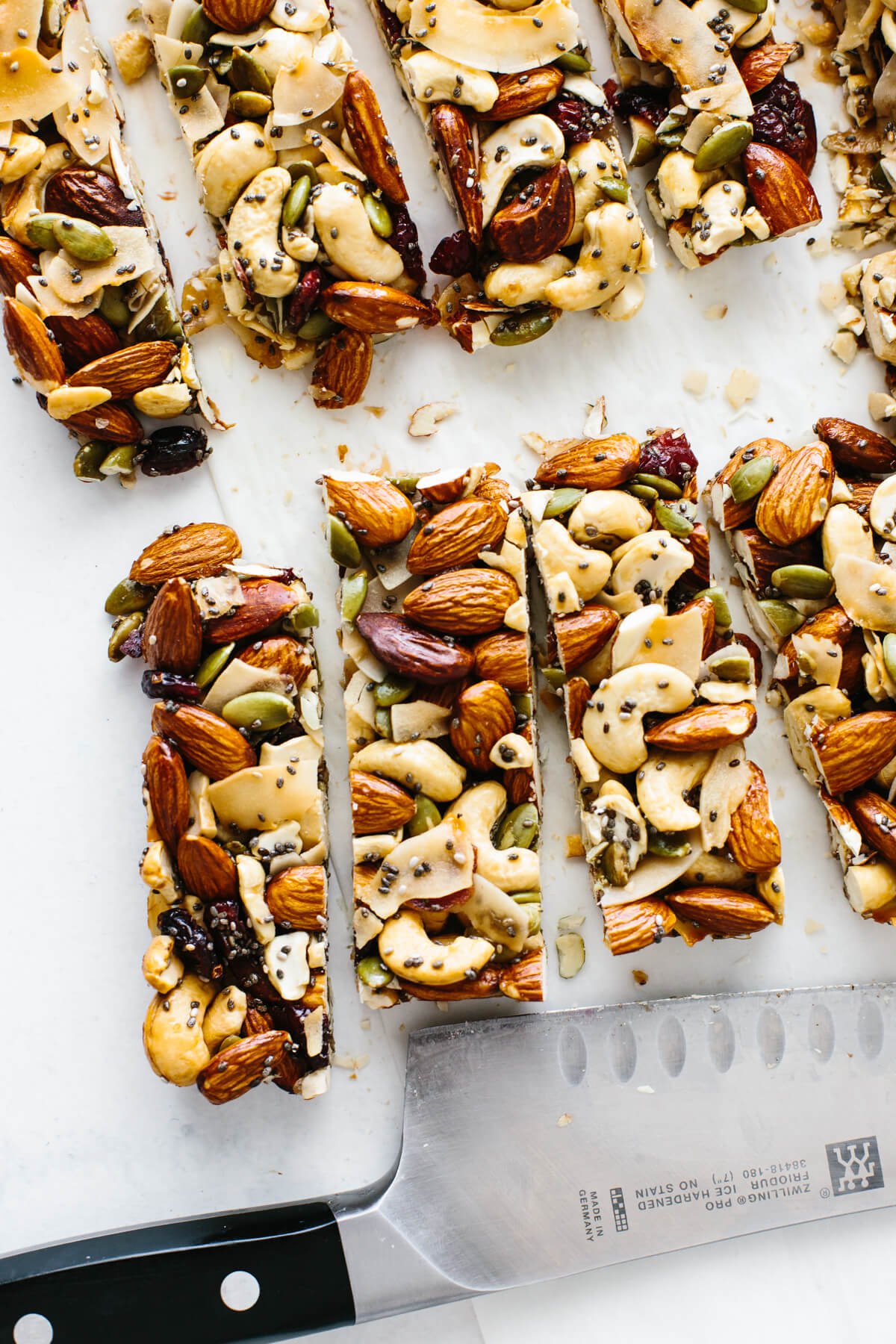 Healthy homemade trail mix granola bars that are gluten-free and paleo friendly! Trail mix bars cut into individual bars next to a knife.