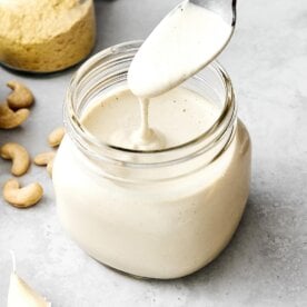 Vegan alfredo sauce in a glass jar.