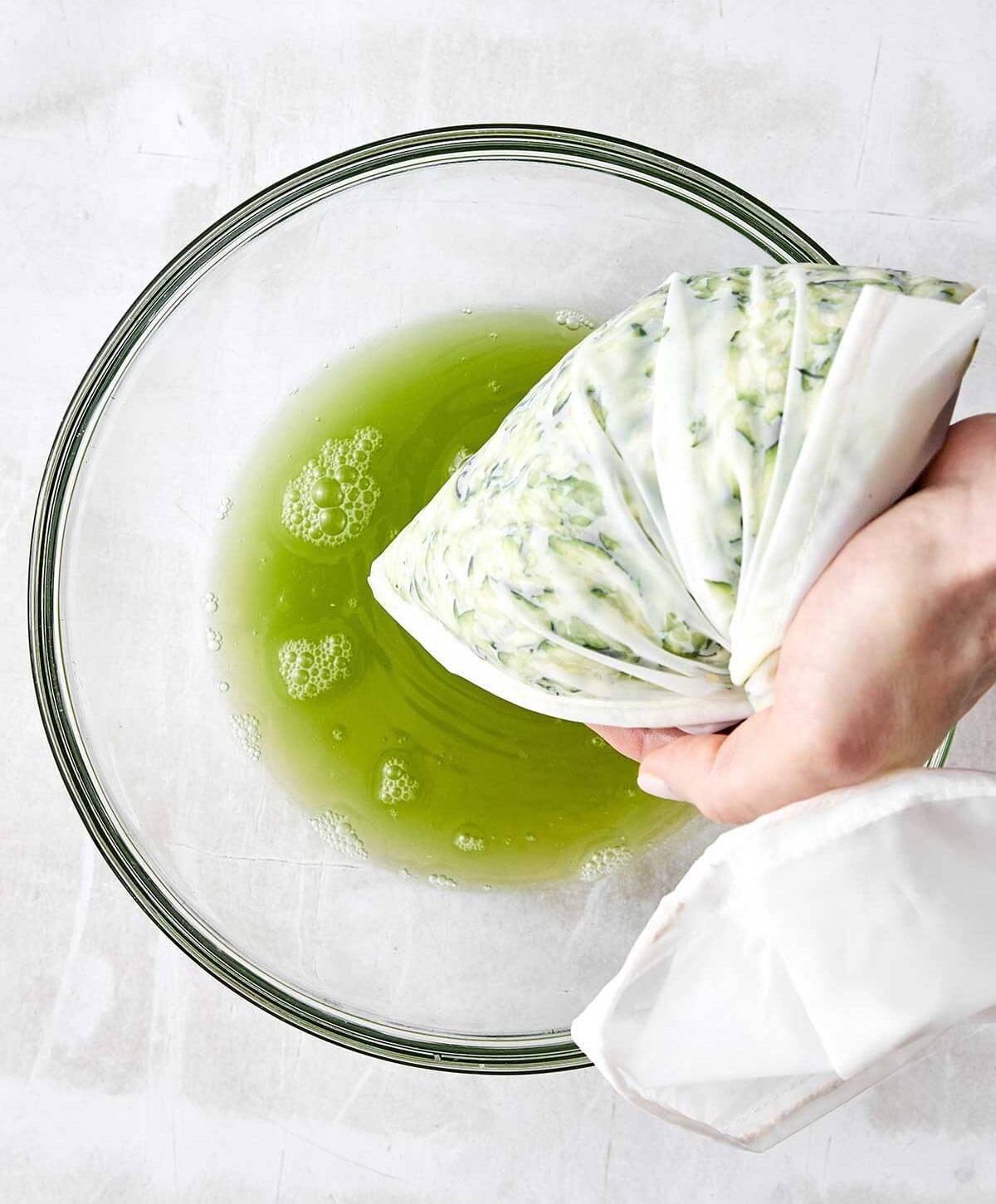 Draining liquid out of grated zucchini.