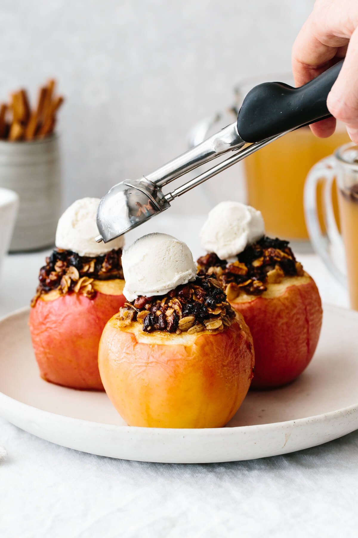 Topping the baked apples with a scoop of ice cream.