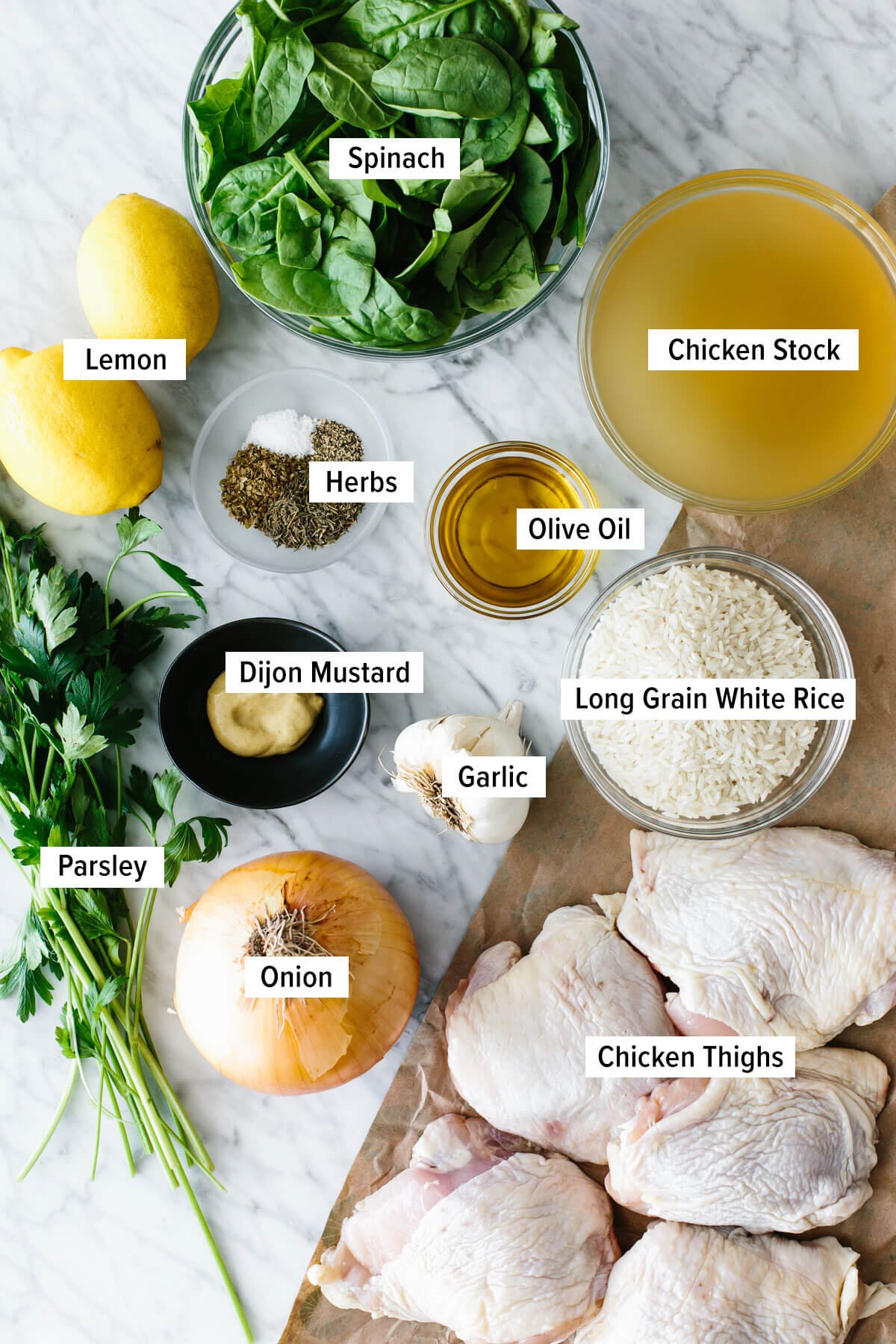 Chicken and rice is an easy, one pan recipe that shines with bright Mediterranean flavors and juicy chicken thighs! Ingredients for chicken and rice on a table