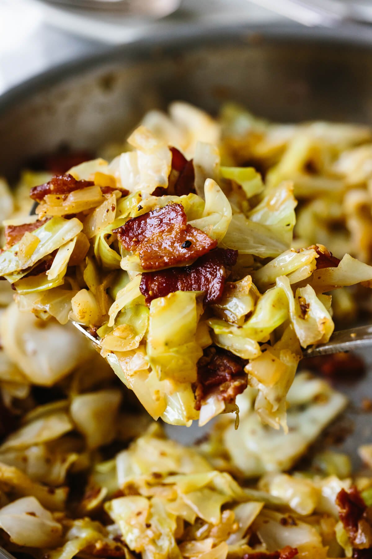 A closeup of a spoonful of fried cabbage.