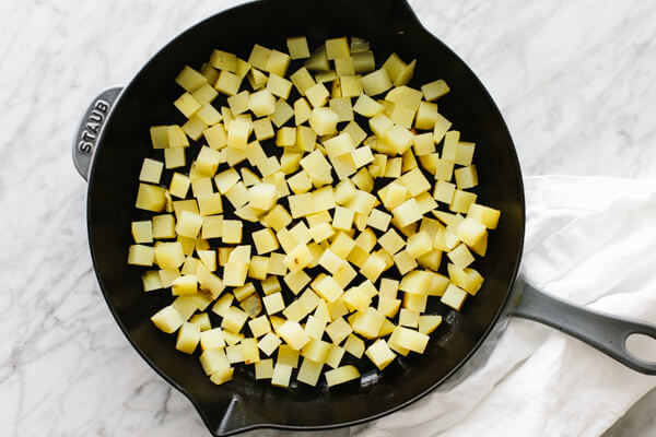 Diced potatoes in a skillet.