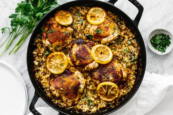 The finished chicken and rice recipe in one pan with garnishes.