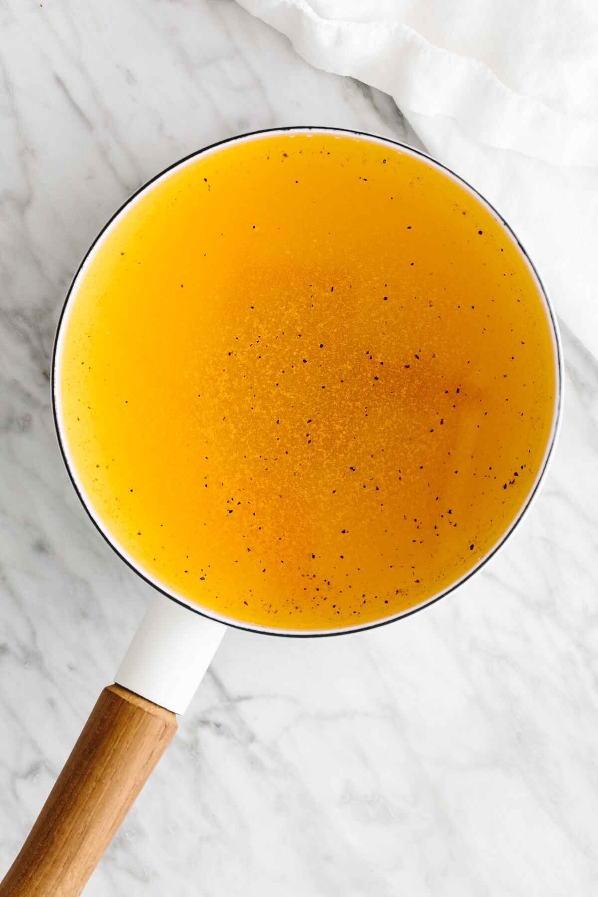 Turmeric tea is a blend of ground turmeric, lemon juice, and honey that's anti-inflammatory and immune-boosting. Turmeric tea ingredients in a pot.