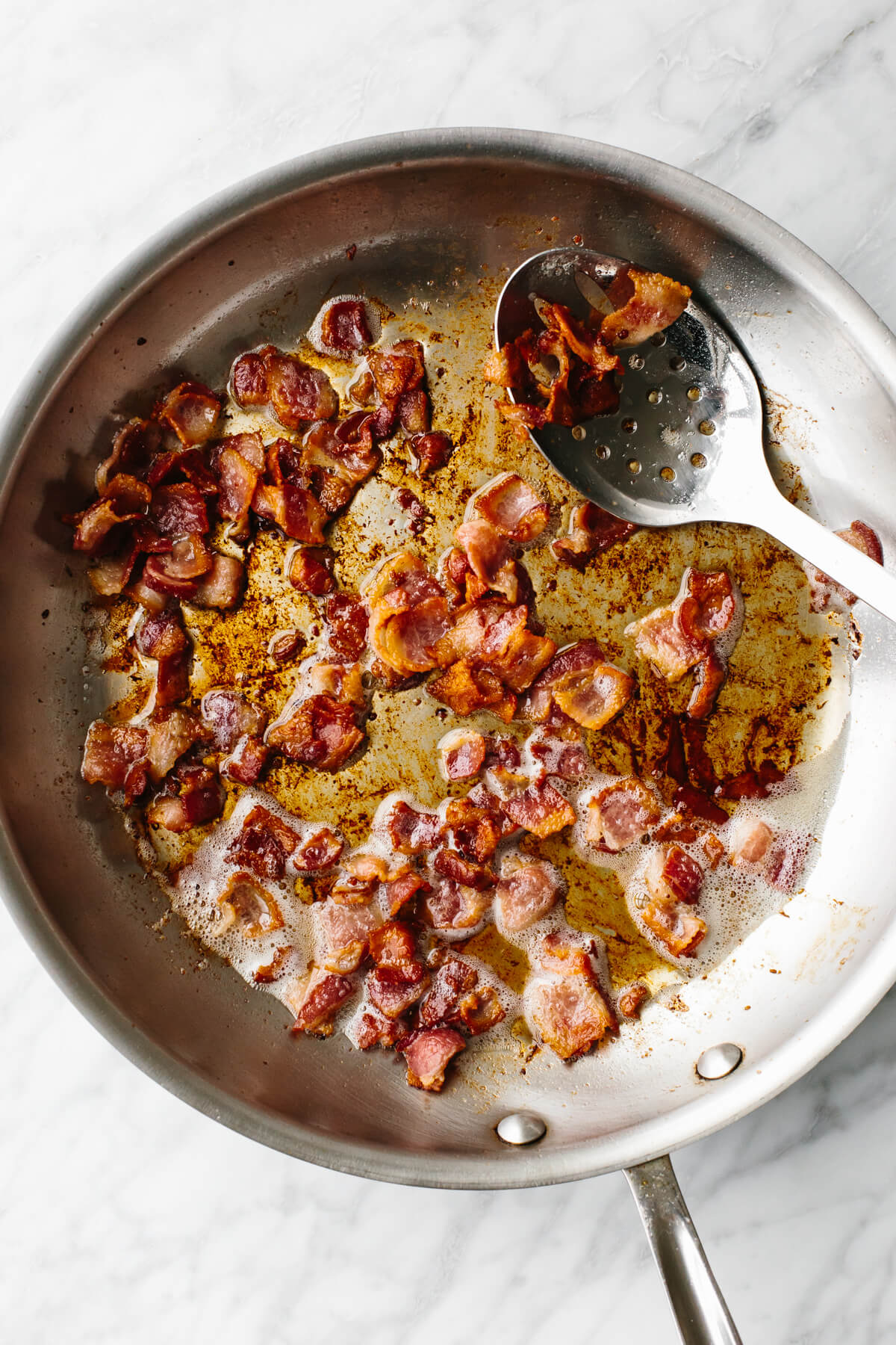 Cooking bacon in pan for fried cabbage