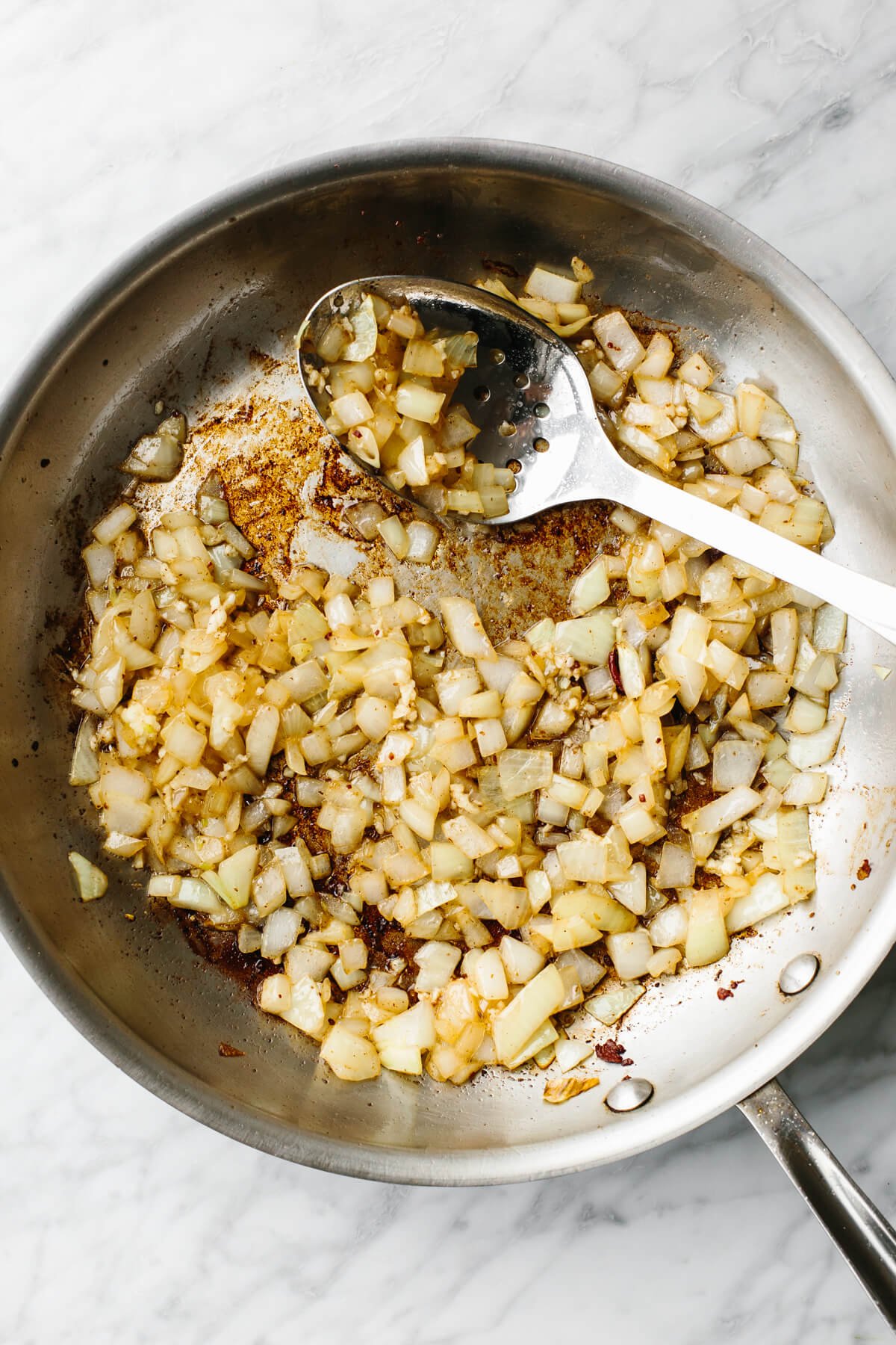 Cooking onions in pan for fried cabbage