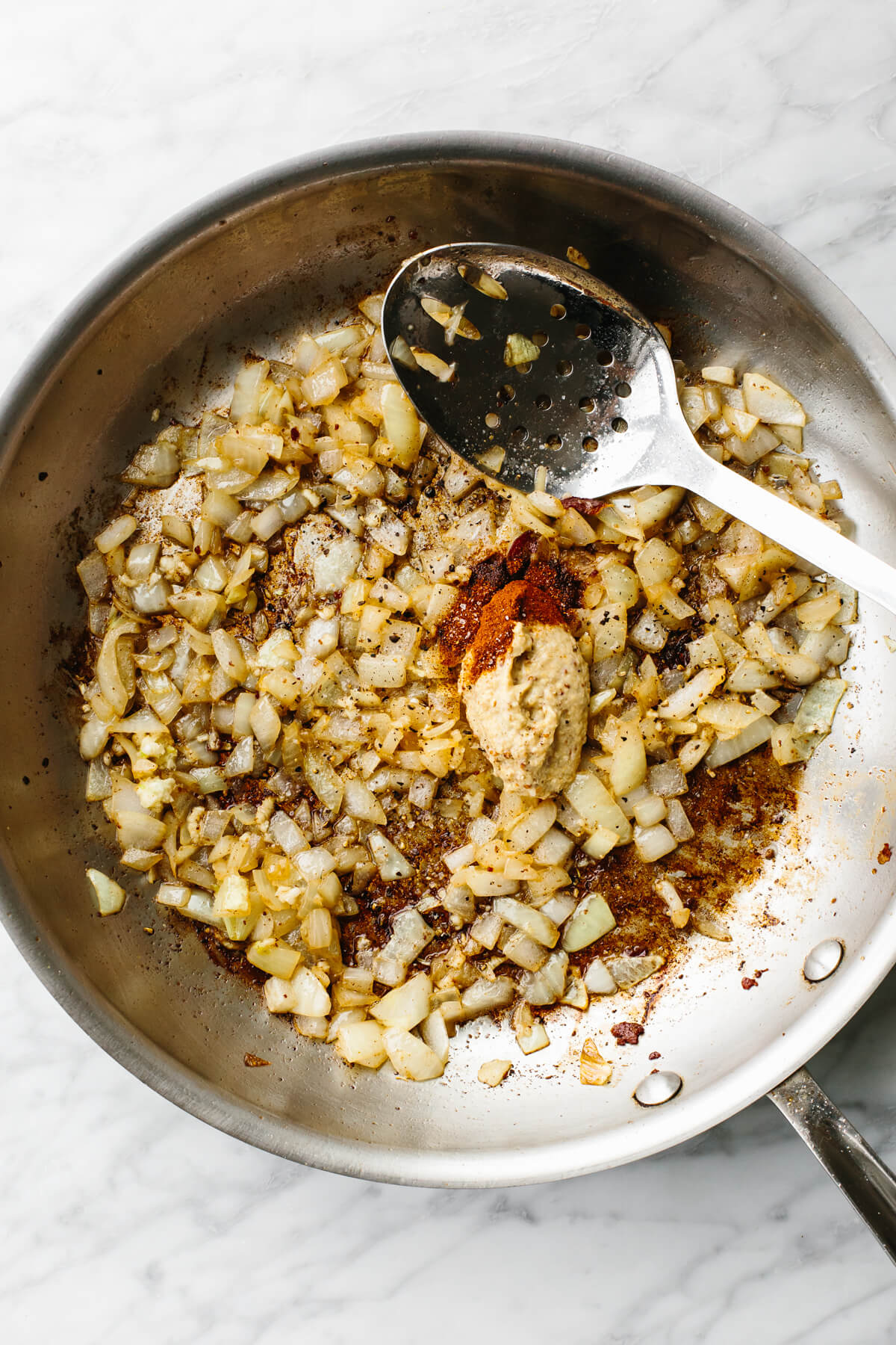 Stirring in seasoning in pan for fried cabbage