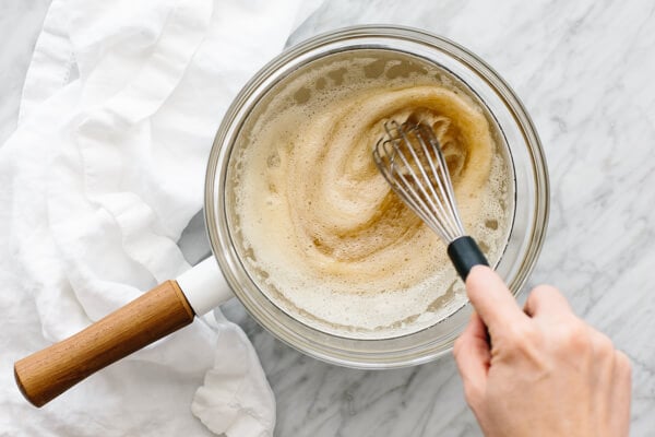 Coconut macaroon mixture being whisked in a bowl.