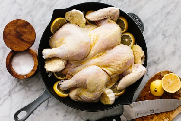 Seasoning a lemon garlic spatchcock chicken.