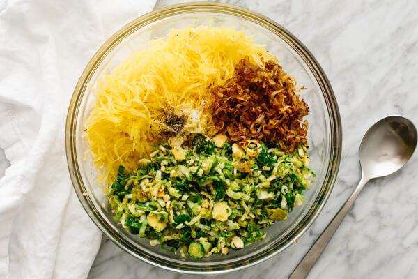 Spaghetti squash, Brussels sprouts, and crispy shallots in a large bowl.