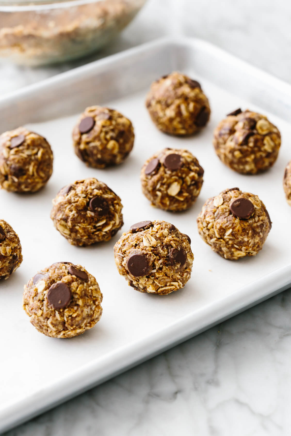 No bake chocolate chip energy balls on a sheet pan.