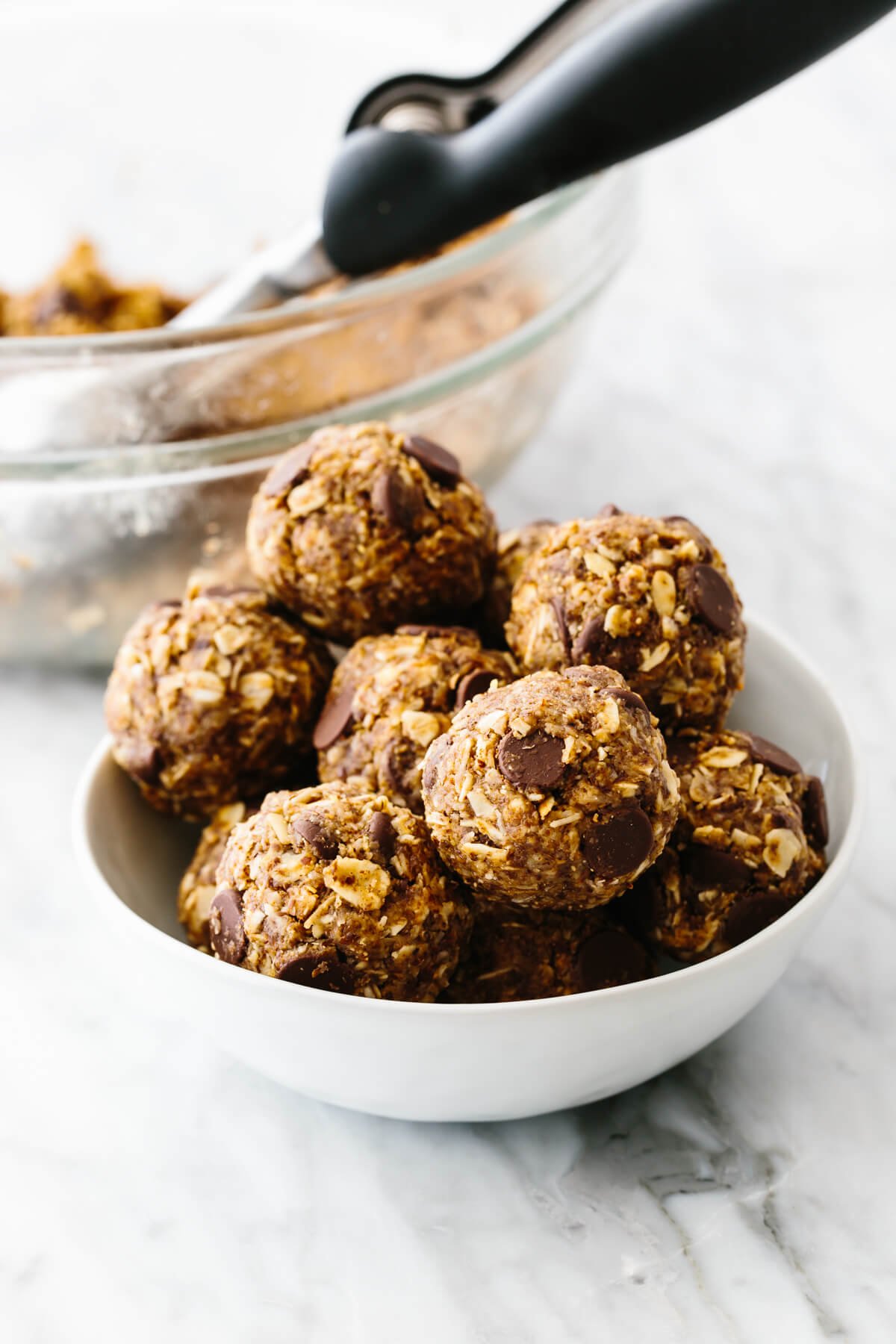 No bake chocolate chip energy balls in a white bowl.