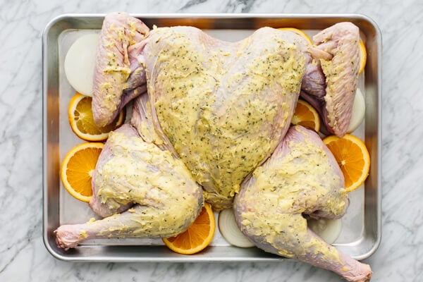Spatchcock turkey on a baking sheet pan.