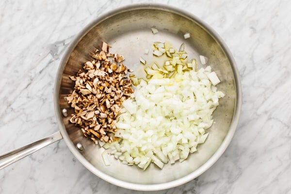 Onions and mushroom in a pan for a turkey casserole.