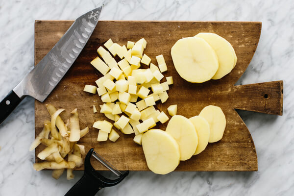 Peeling and dicing the potatoes.