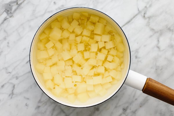 Boiling the diced potatoes in a pot of water.