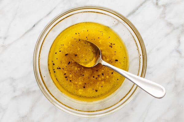 Apple cider vinaigrette in a bowl for a turkey cobb salad.