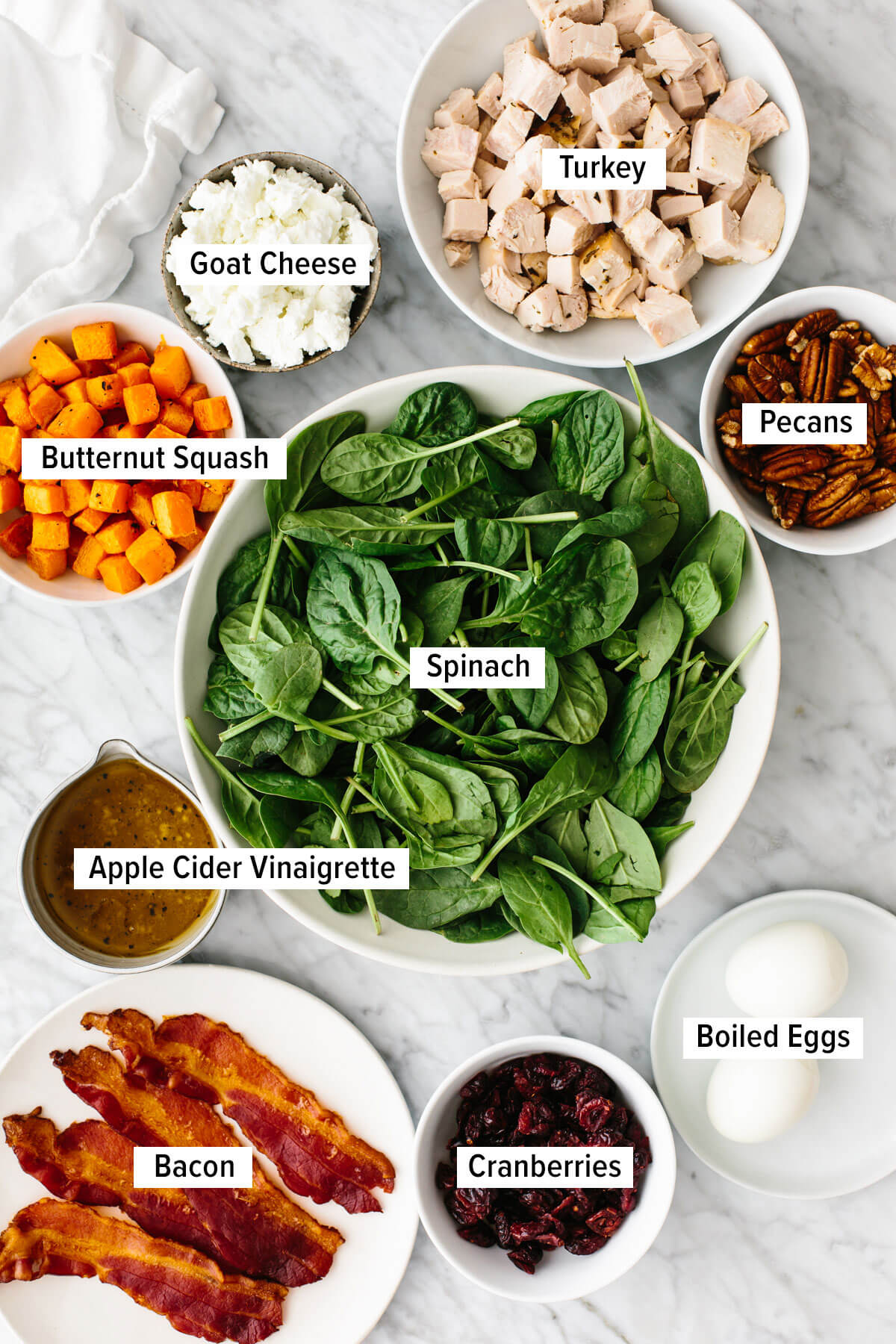 Ingredients for a turkey cobb salad laid out on a table.