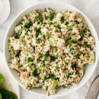 A bowl of broccoli tuna salad on a table.