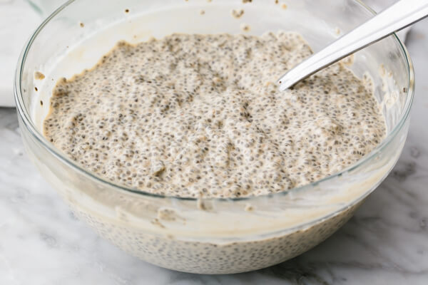 Mixing eggnog chia pudding in a large bowl.