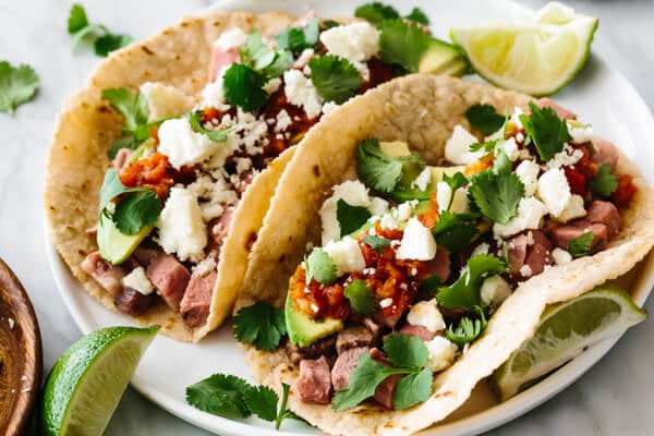 Prime rib tacos stuffed with ingredients.