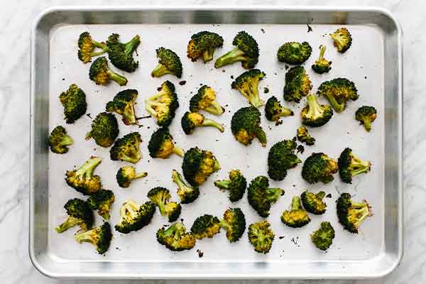 Roasted broccoli on a sheet pan.