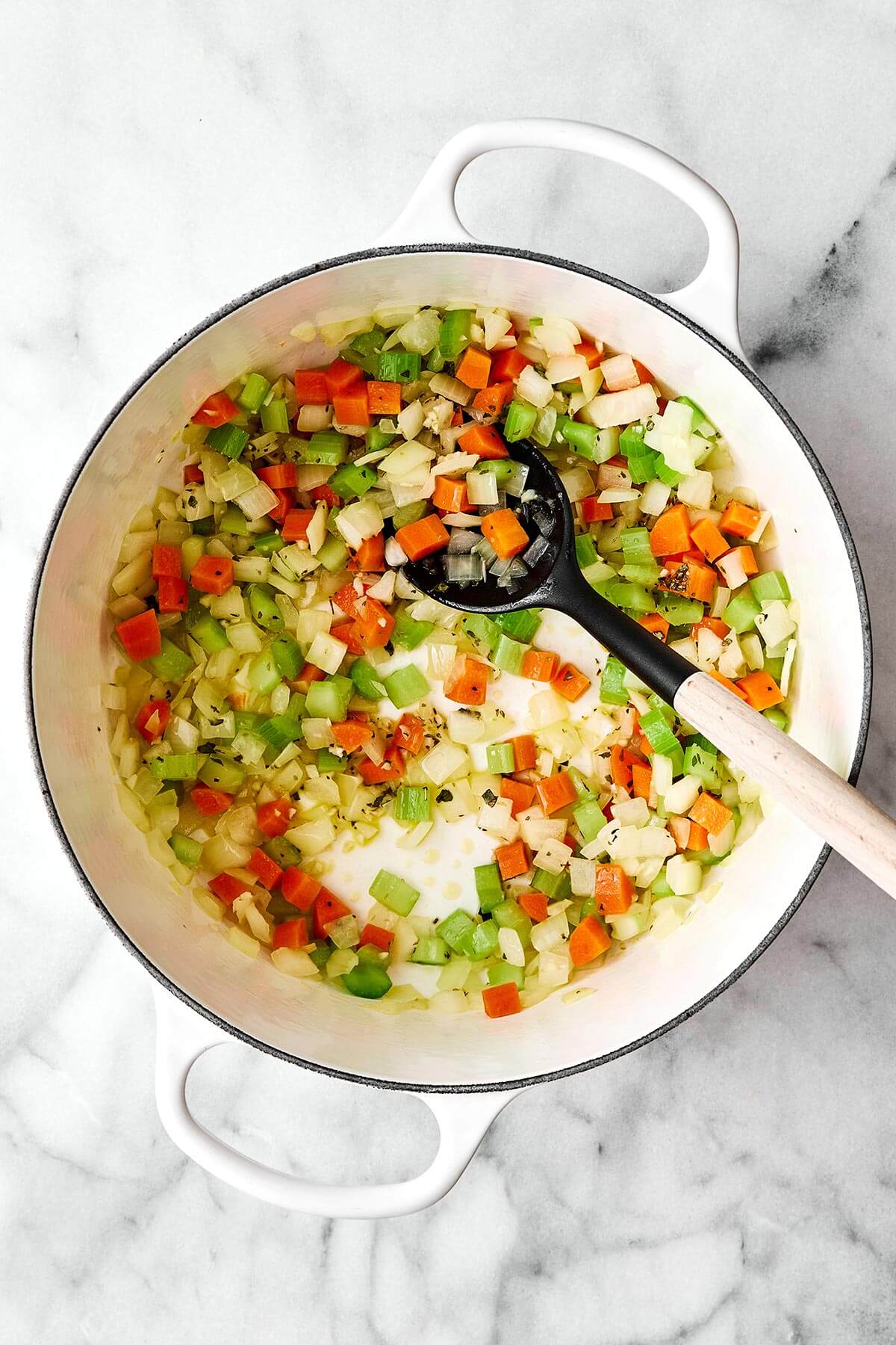 This cabbage soup is just what you need for soup season. It's light and simple, but extremely healthy, comforting, and delicious! Cooked mirepoix vegetables in a pot.
