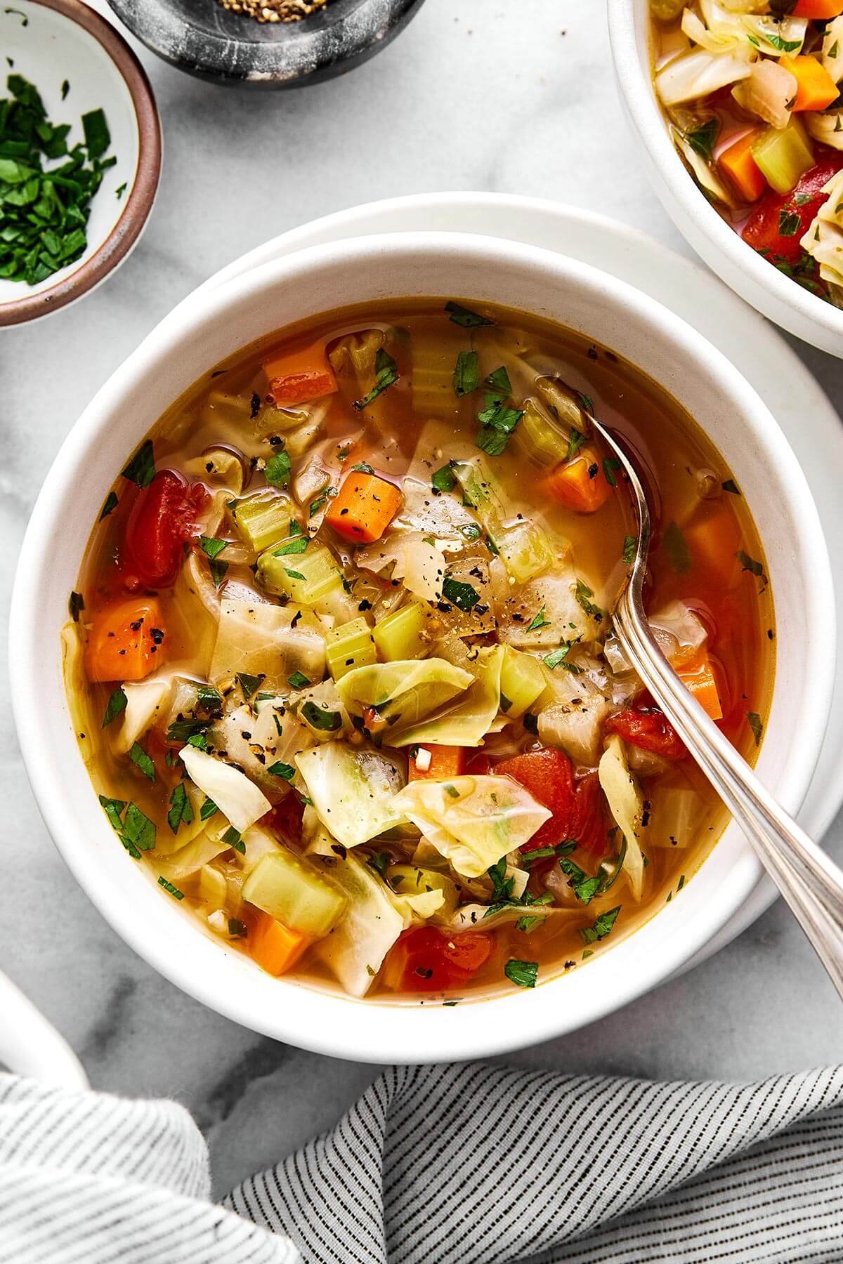 This cabbage soup is just what you need for soup season. It's light and simple, but extremely healthy, comforting, and delicious! A bowl of cabbage soup.