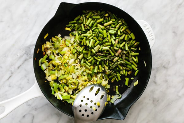Sauteeing leeks and asparagus for spring vegetable frittata