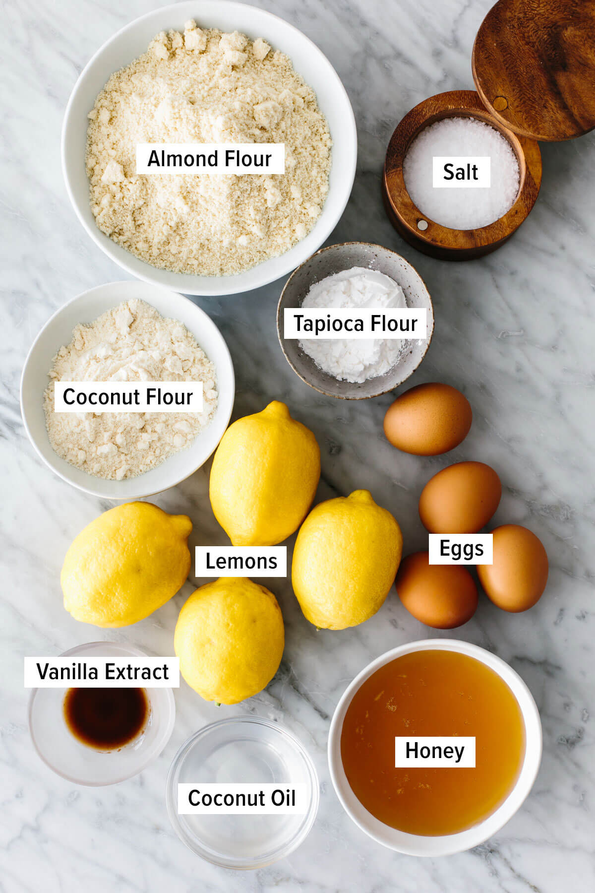 These lemon bars have a gluten-free shortbread-like crust and a bright, luscious filling that's the perfect balance of sweet and tangy! Ingredients for gluten-free lemon bars on a table.