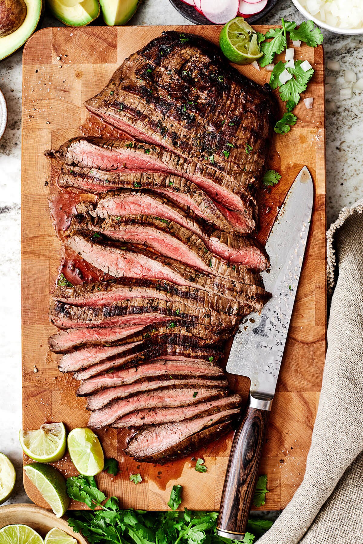 When it comes to the best carne asada, nothing beats this tried and true recipe loaded with authentic Mexican flavor! Sliced carne asada on a cutting board