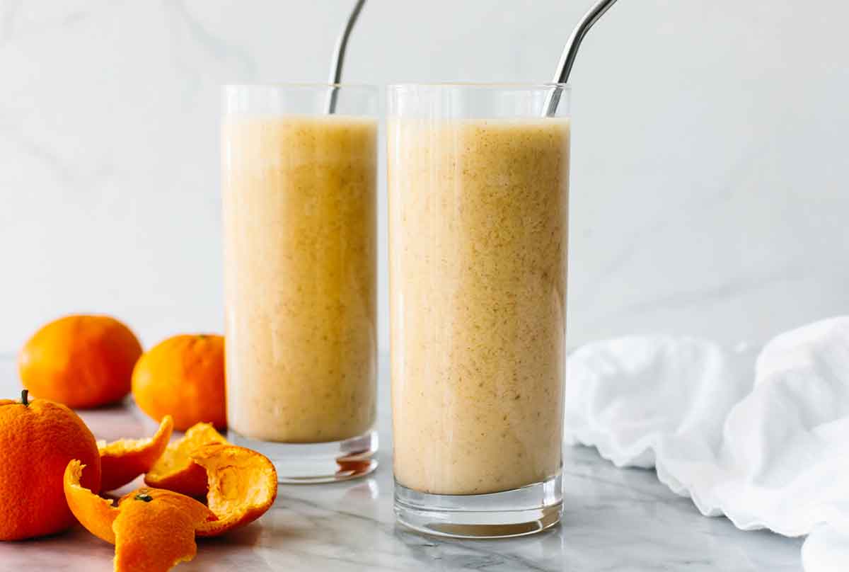 Two cups of mandarin breakfast smoothies.