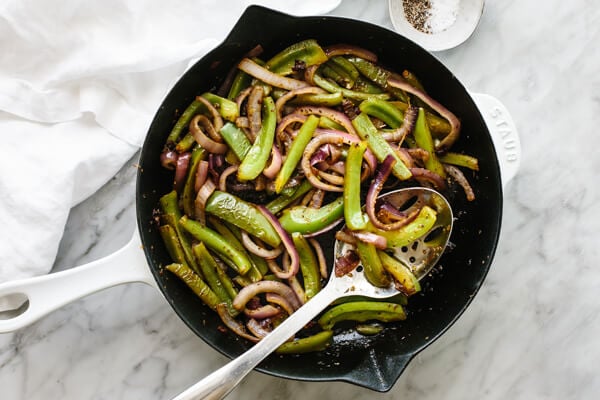 A skillet with sauteed fajita veggies